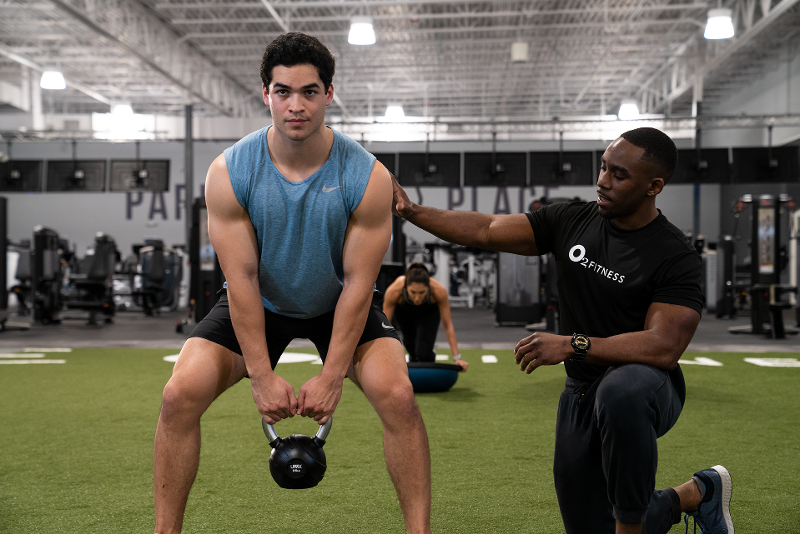 Man Holding Weights in a Personal Training Session