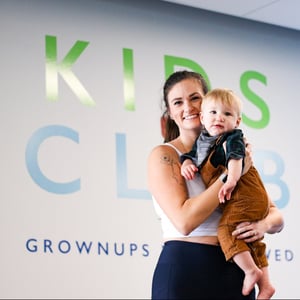 woman holding a child in Kids Club at O2 Fitness Clubs