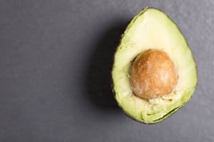 Exotic fresh avocado on black slate with copy space