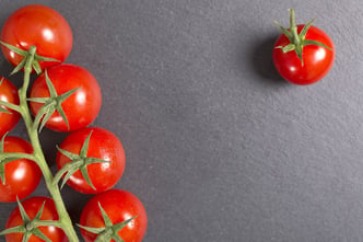 Fresh ripe tomatoes on black slate