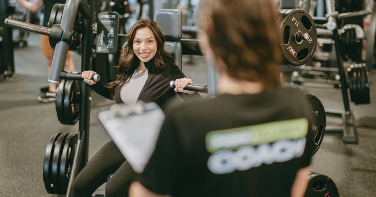 Woman weightlifting with her personal trainer