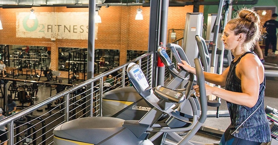 woman using a lateral elliptical at an O2 Fitness Clubs location
