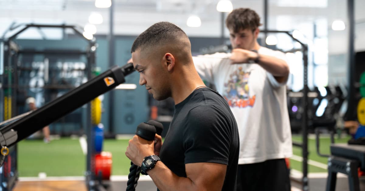 two men lifting at O2 Fitness Clubs on the cable machine