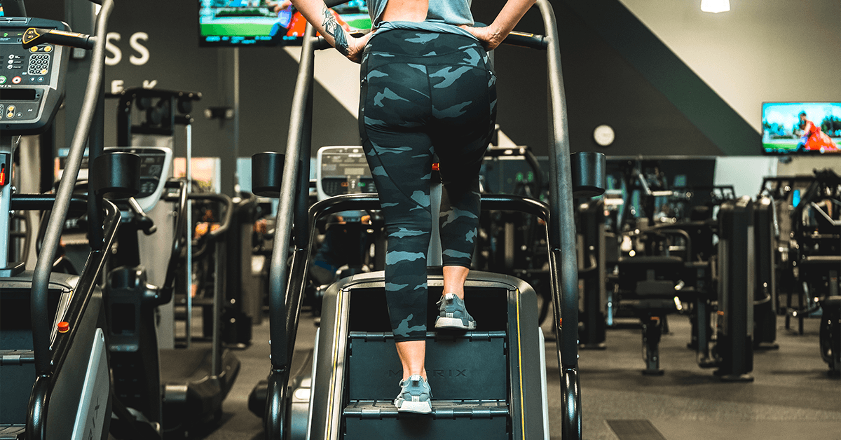 woman using the StairMaster inside an O2 Fitness Clubs location