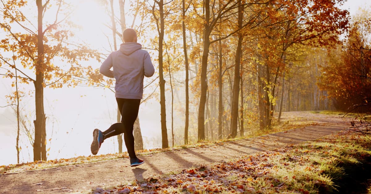 a man running outdoors on a trail through a local park in north carolina 