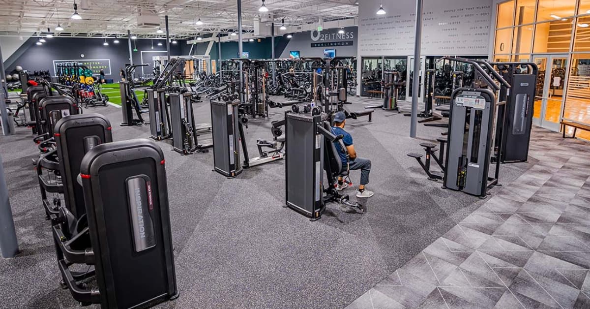 O2 Fitness Clubs gym floor full of machines, weights, and other gym equipment